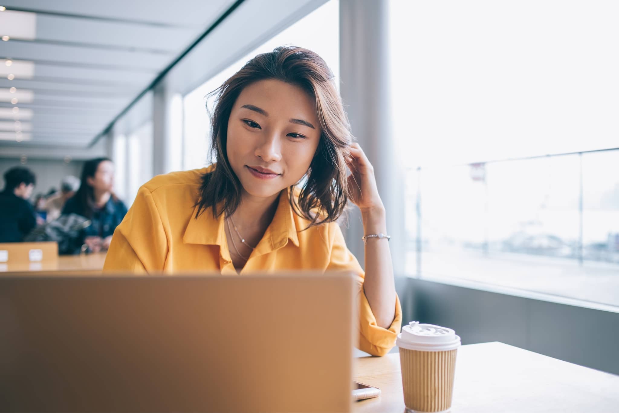 Young woman smiling at laptop