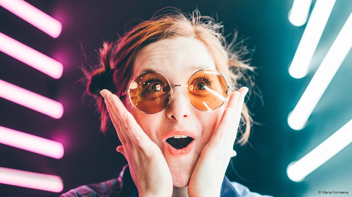 Young girl that is very excited with her hands on her face