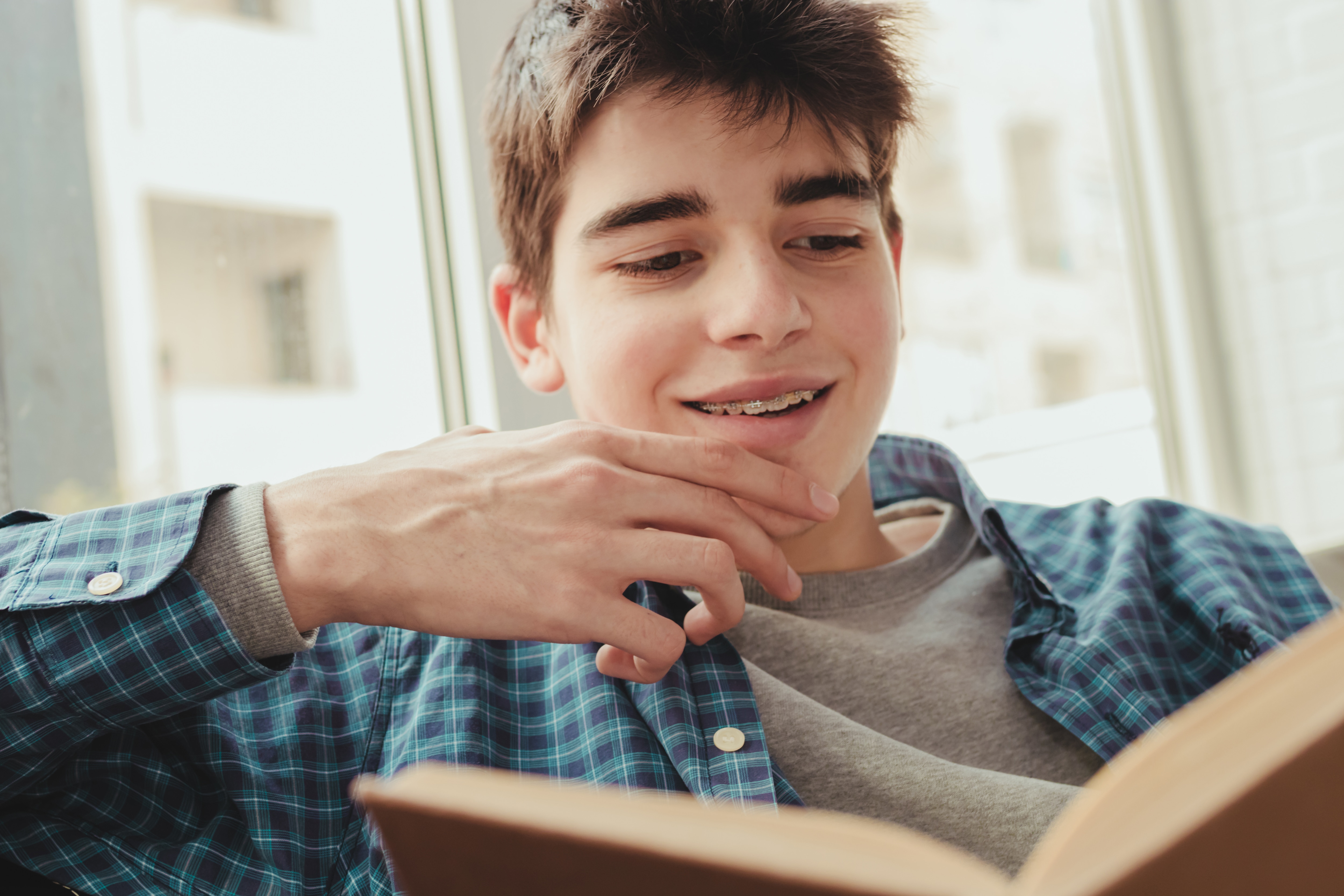 Teenage boy reading a book