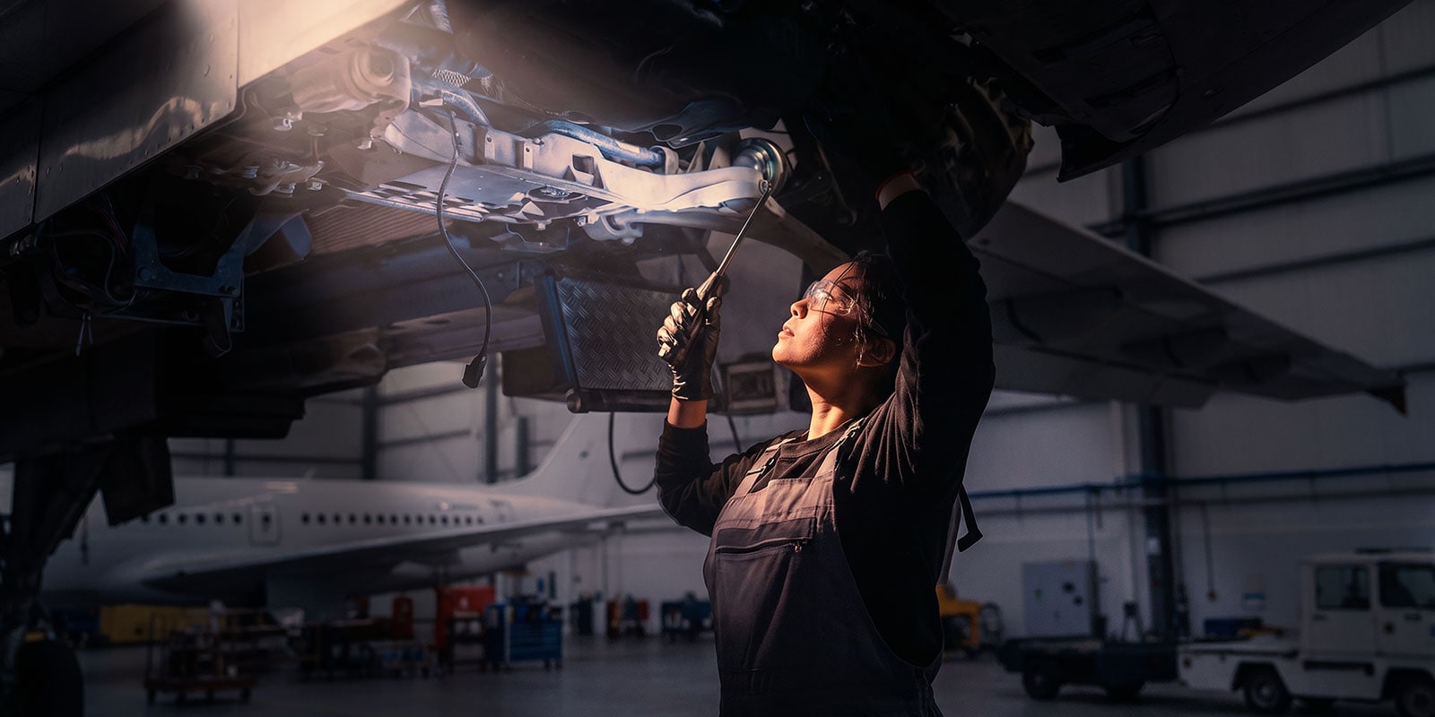 WorldSkills International Partnership - Image of student with tools working on an engine of a plane
