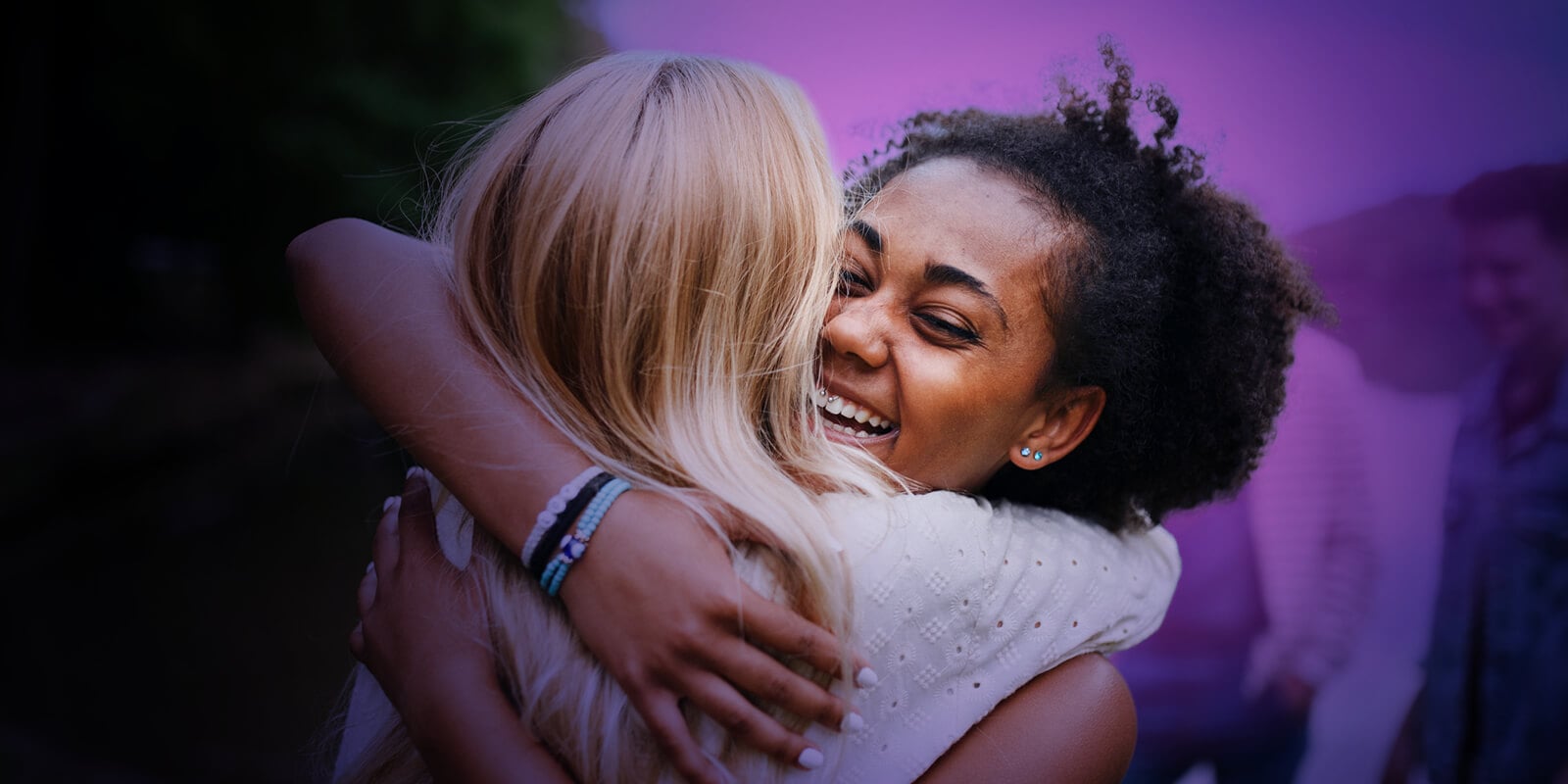Students smiling and hugging