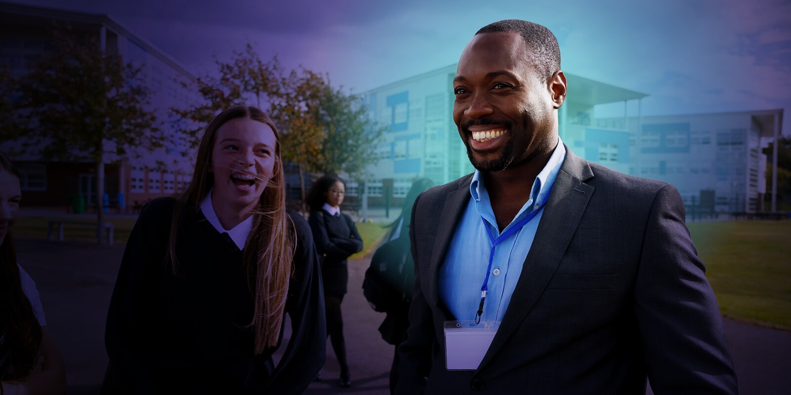 Teacher and student smiling outside a school