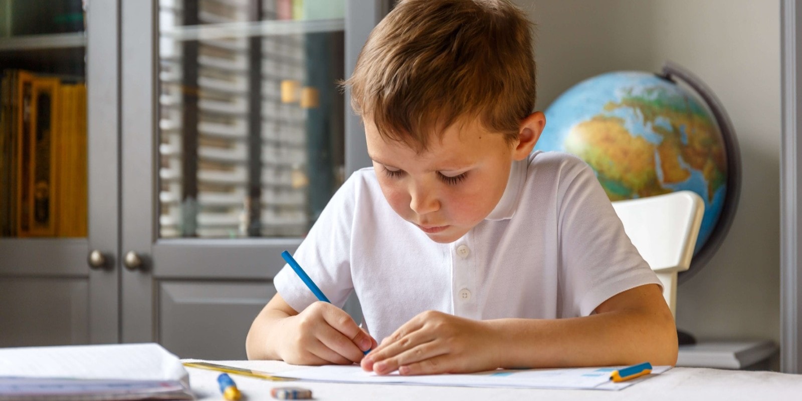 Male pupil doing homework
