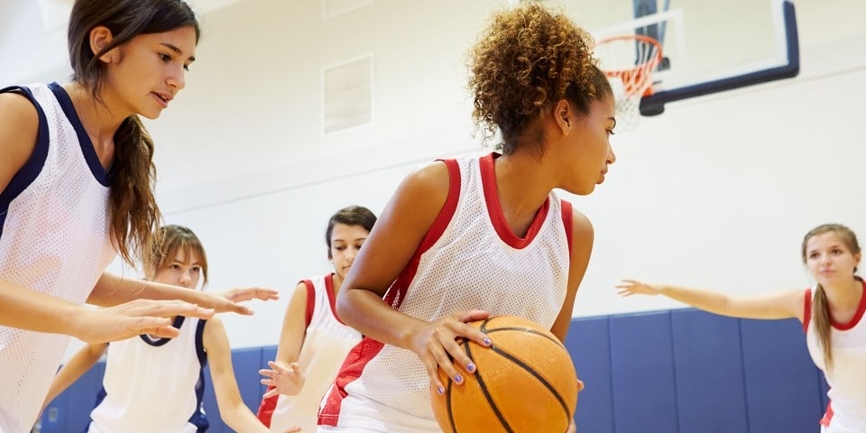 Young women playing basketball