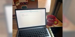 A laptop with Pearson+ flashcards open on the screen alongside a red mug with the Rutgers University logo.