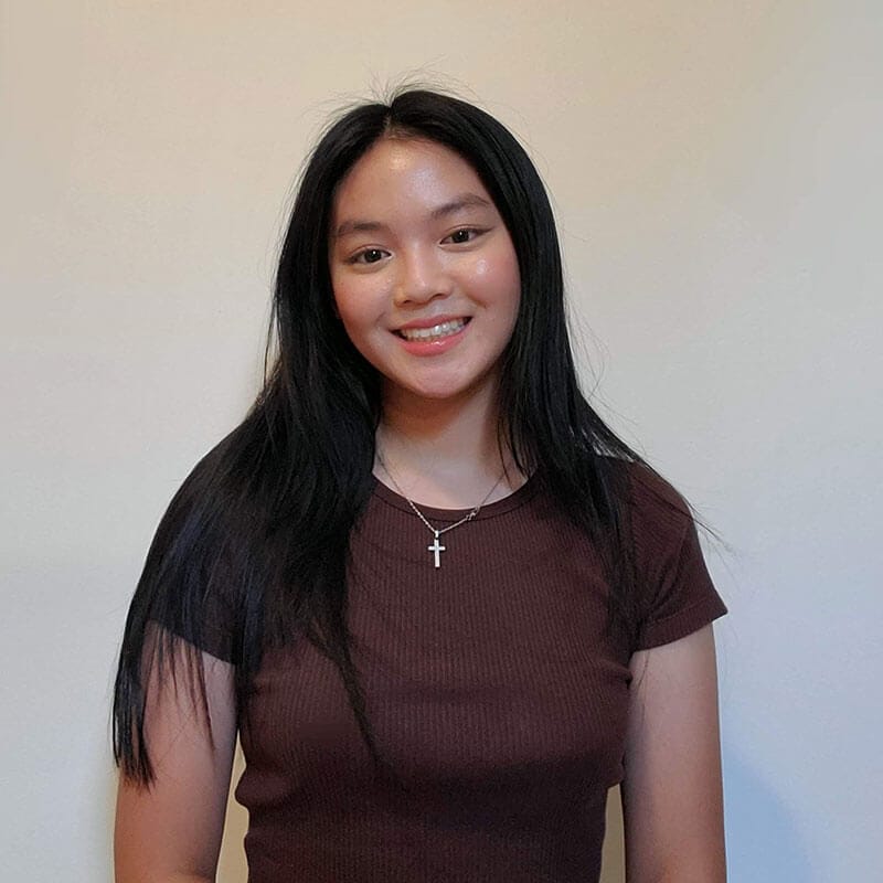 Blog author Melody has long dark hair and is wearing a dark red t-shirt.