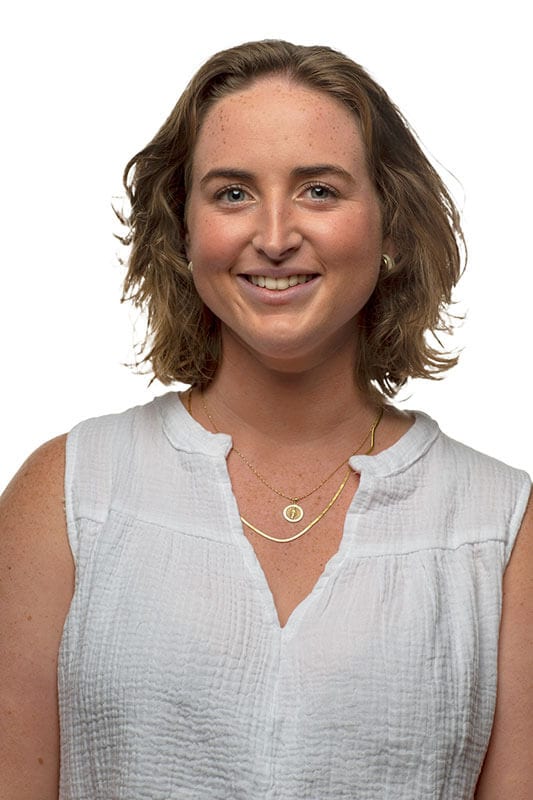 Blog author Molly has shoulder-length wavy brown hair. She is wearing a white sleeveless shirt.