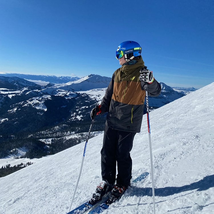 Blog author Maggie Parker is on a snowy mountain skiing. 
