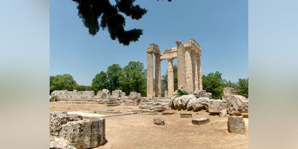 Ancient ruins located somewhere in the European Union featuring partially intact columns and boulders on ground.