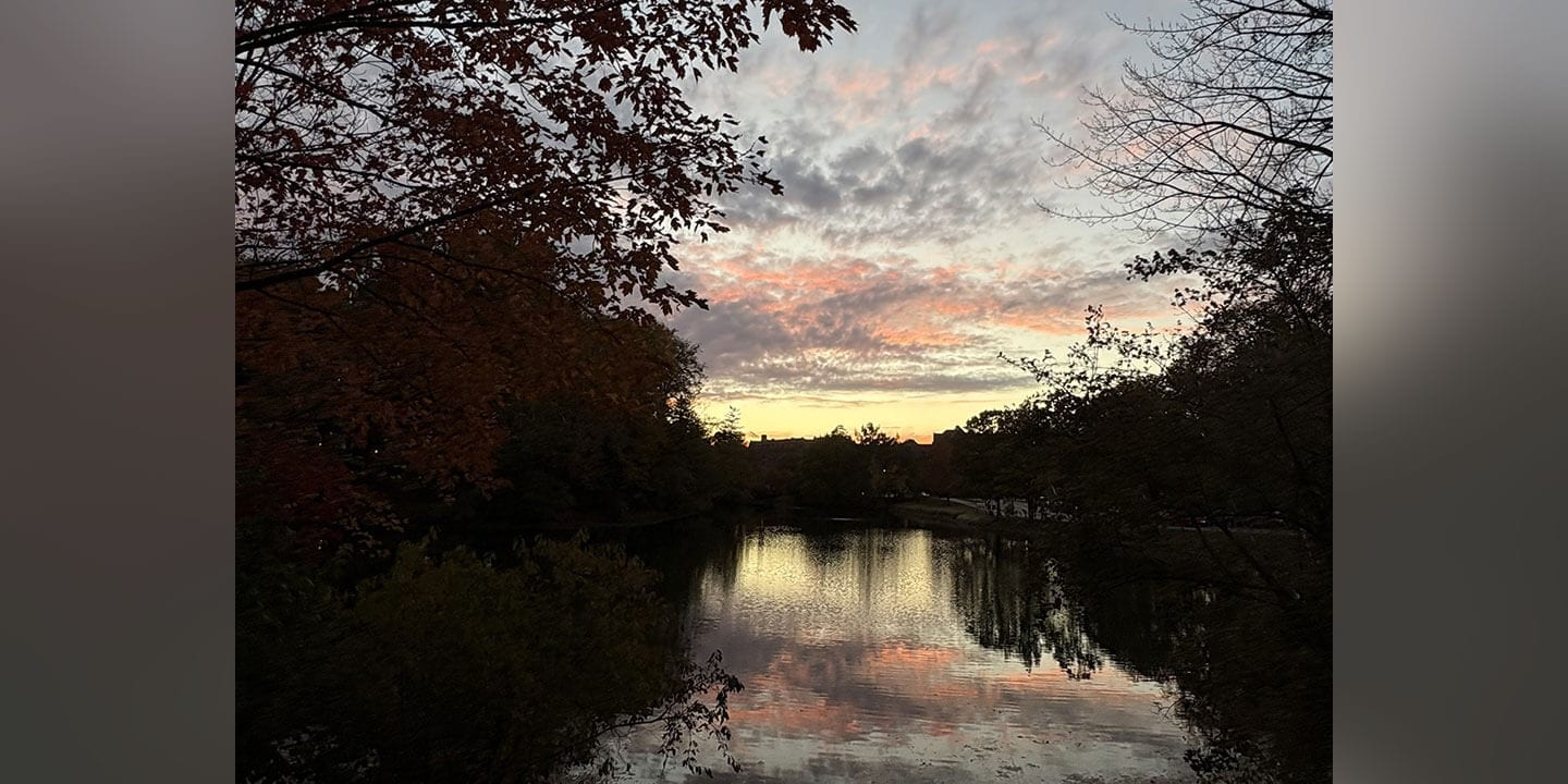 Sunset pictured over a lake at dusk.