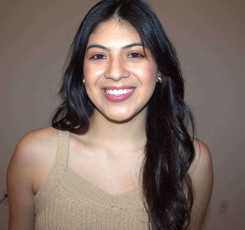 Blog author Andrea has long straight dark hair and is wearing a sleeveless sweater.