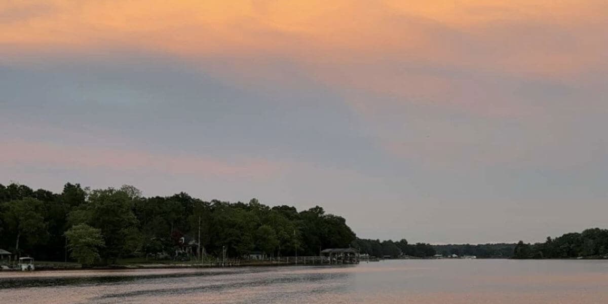A lake with docks and boats along the shore.