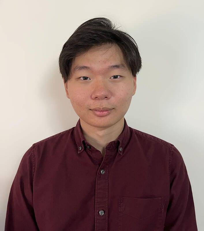 The blog author, John, has short, dark hair, and is wearing a dark red button up shirt.