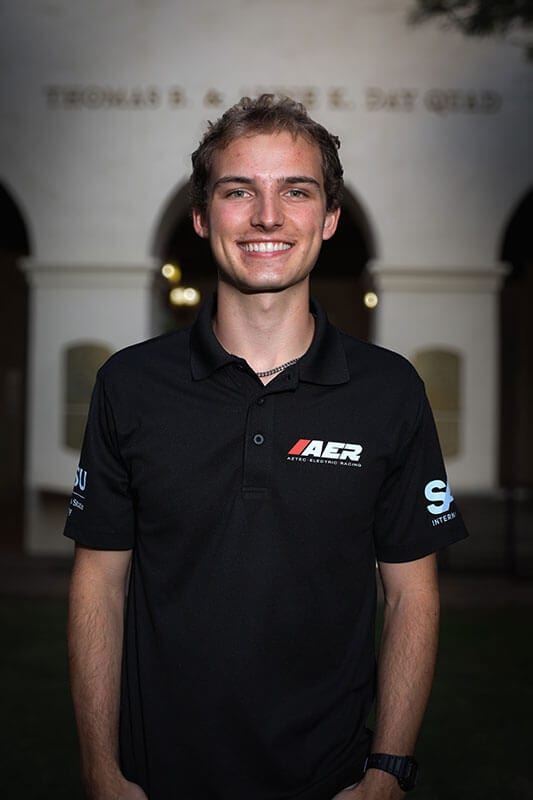 The blog author has brown hair and is wearing a black polo with an AER emblem on it.