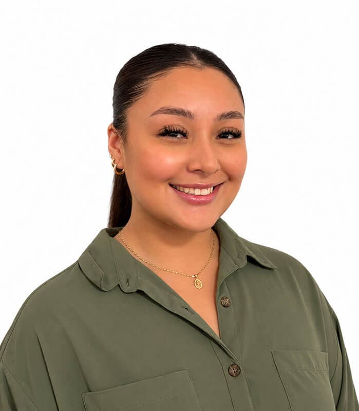 The blog author, Joslyn, has long dark hair pulled back in a ponytail and is wearing an olive-green blouse with buttons down the front and a gold necklace.