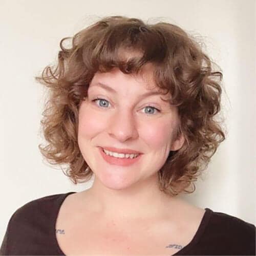 The blog author, Katelyn, has medium length light brown curly hair and is wearing a brown top.