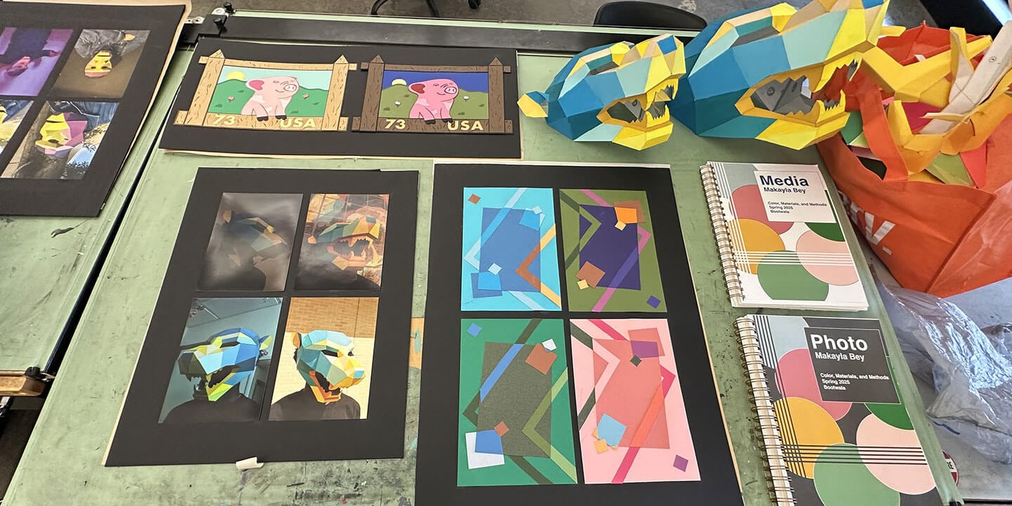 A student’s colorful art portfolio is displayed on a table most likely in an art studio or classroom.
