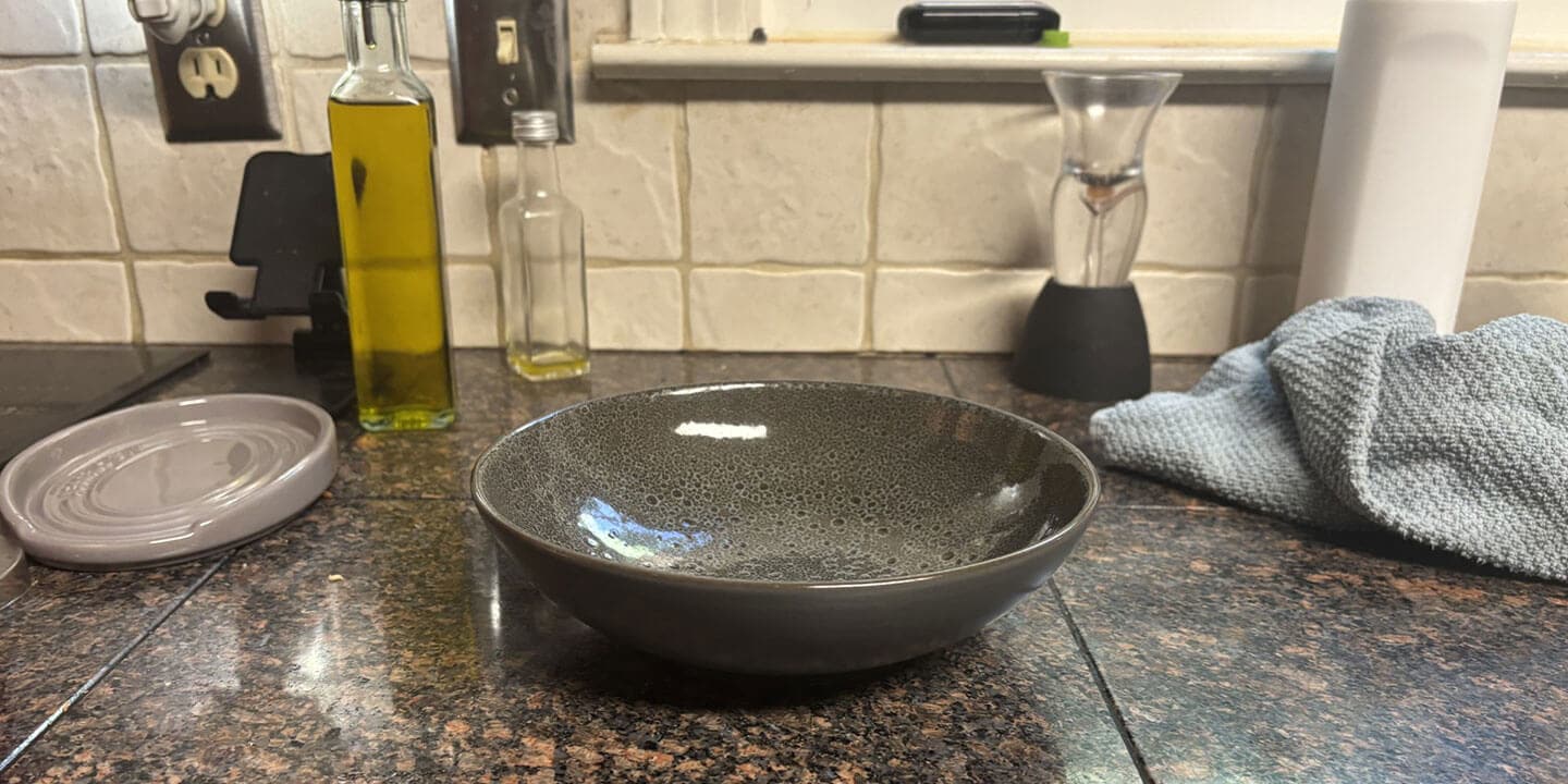 An empty bowl on a kitchen counter.