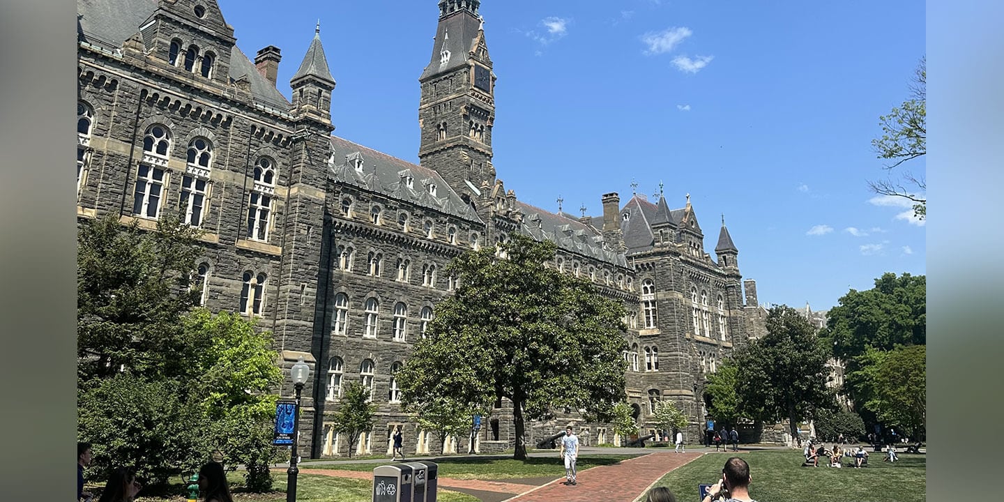 A large, historic stone building on a college campus.