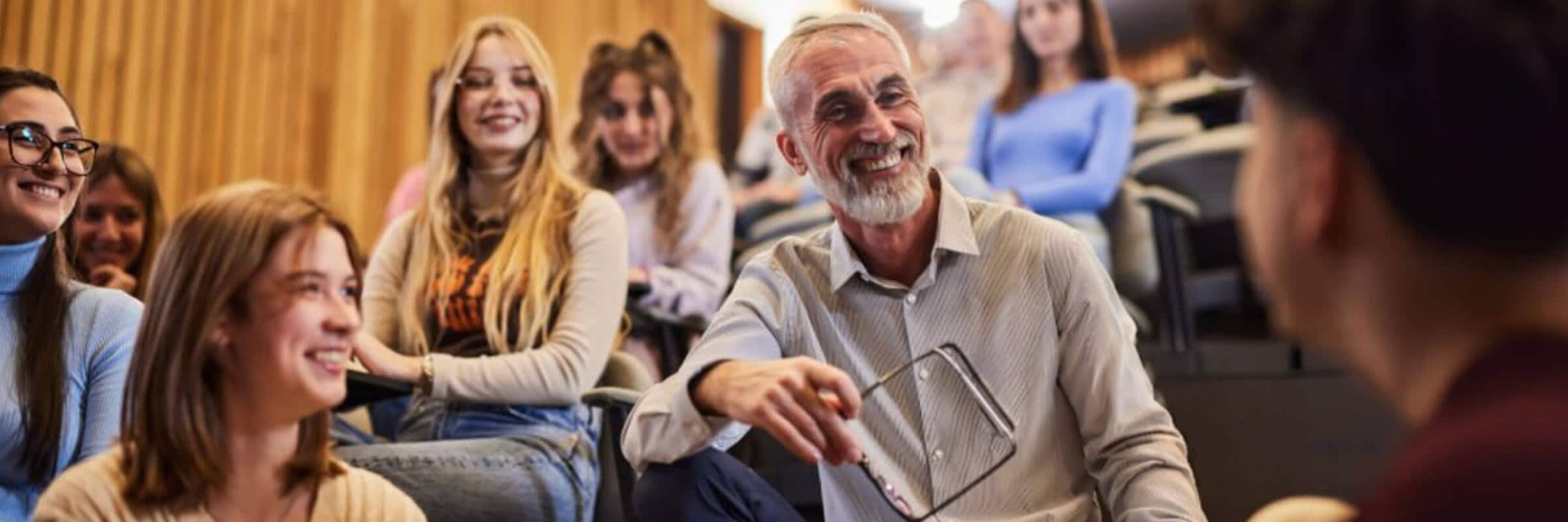 man smiling with students