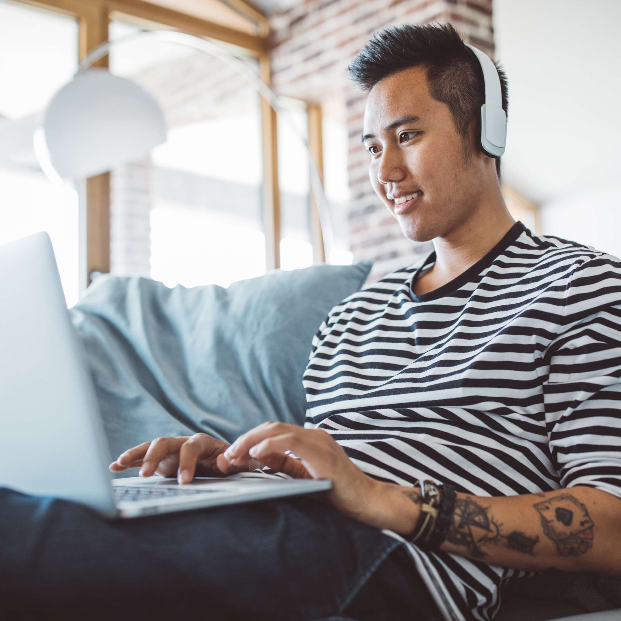 Student smiling while looking at laptop