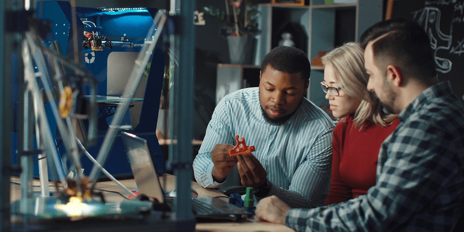 Three students working on a project together.