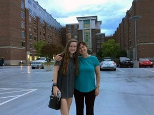 The blog author and her mom standing outside a residence hall on campus.