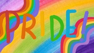 A rainbow themed painting with the word ‘PRIDE!’ in various colors.