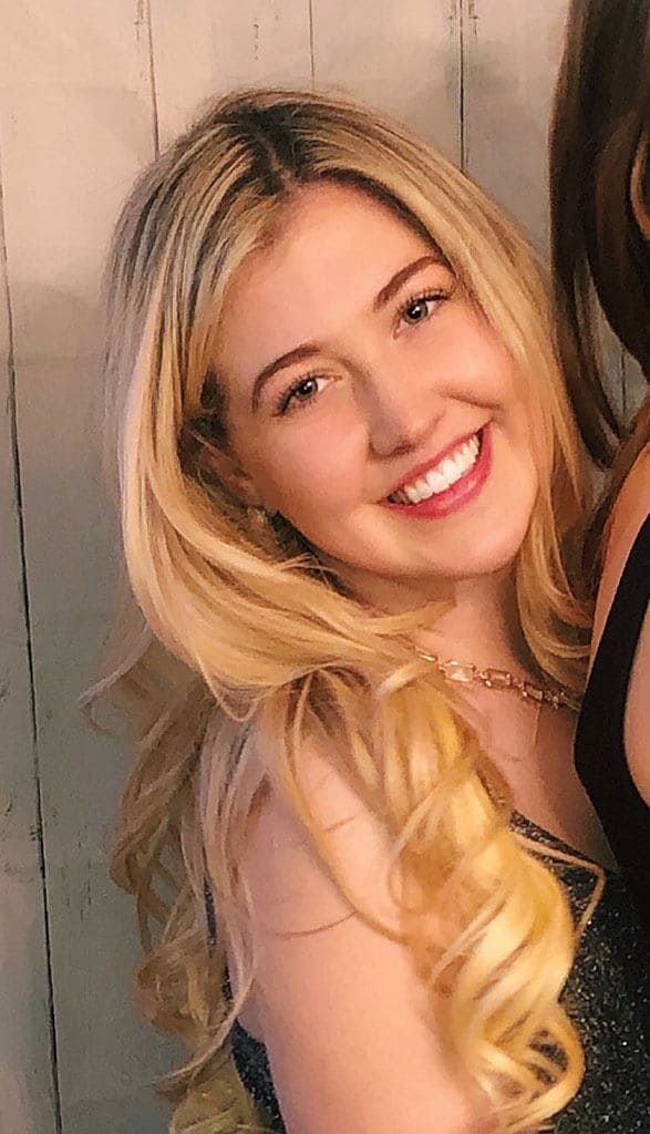 Blog author Sophie Harrison is standing sideways and smiling towards the camera. She has long blonde hair and is wearing a sleeveless top.