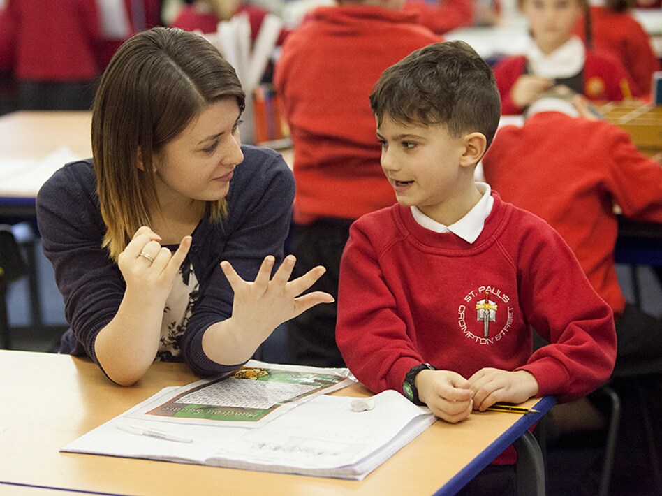 Teacher and child in the classroom counting on their fingers