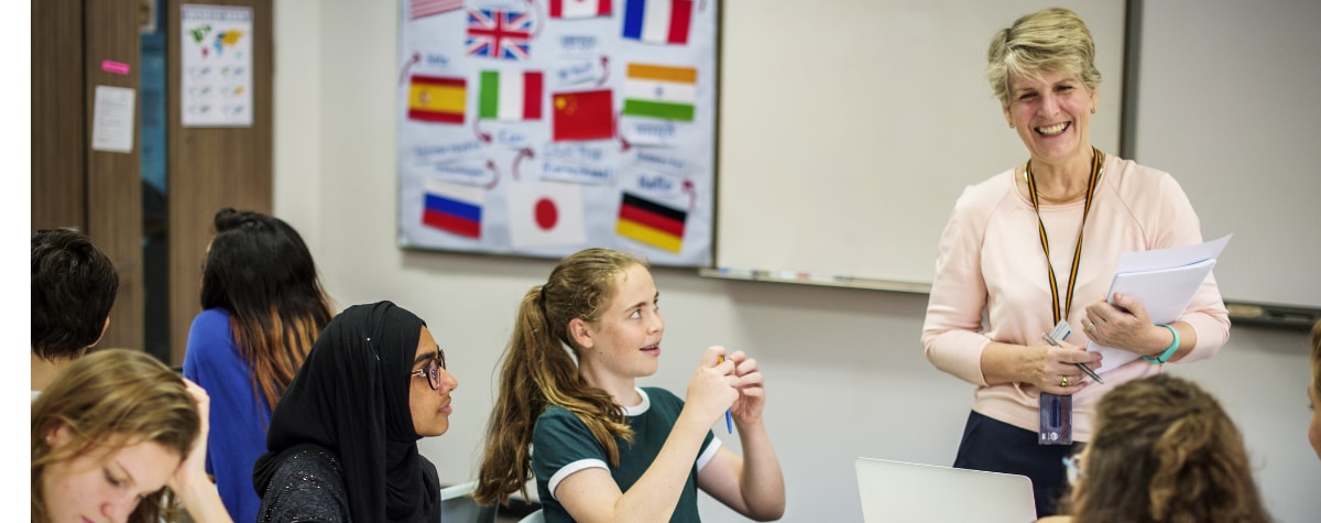 primary students looking at teacher