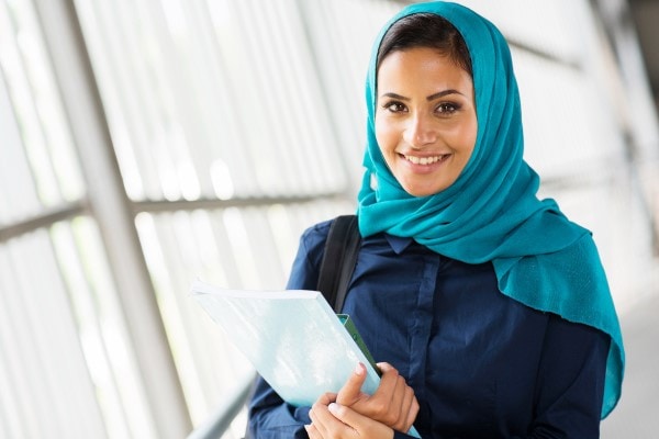 Female student holding a laptop
