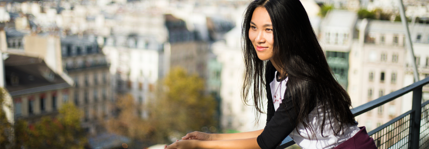 A woman learning outdoors looking at a sceneic view 