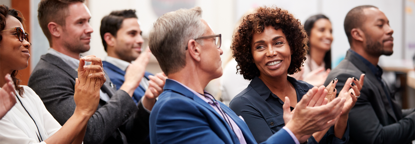 A group of business people clapping their hands