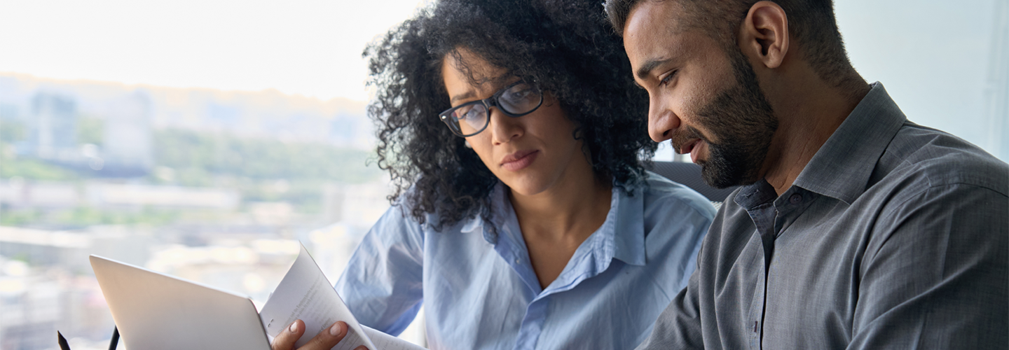 Two business professionals loooking at notes together