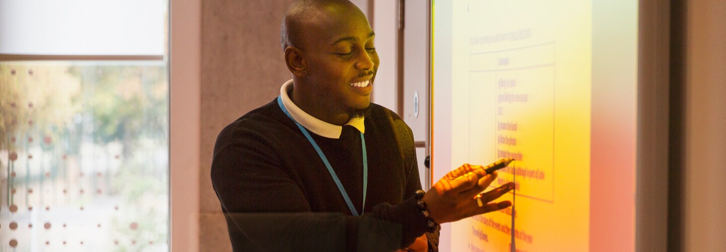 A teacher working on a interactive whiteboard