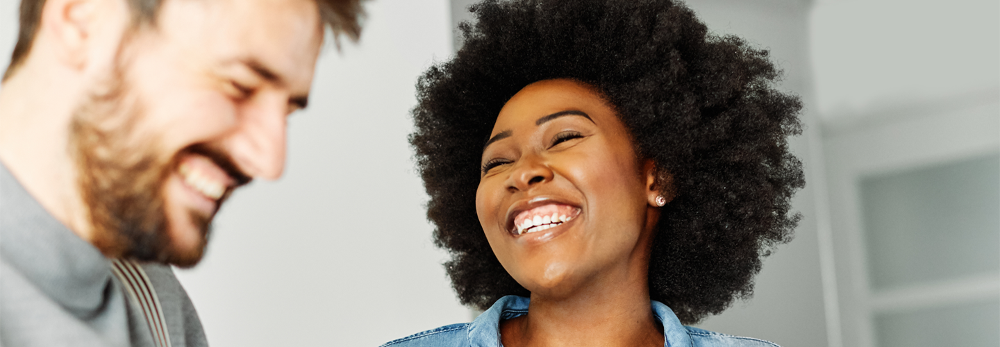 Man and a woman stood together smiling