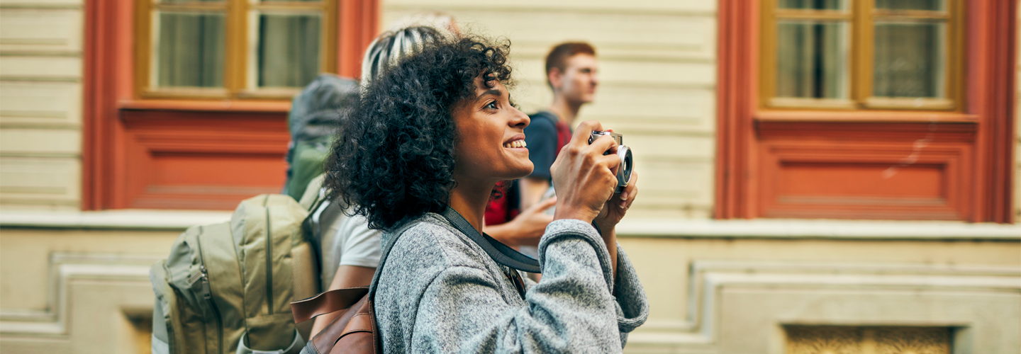 A woman walking around outdoors with a camera