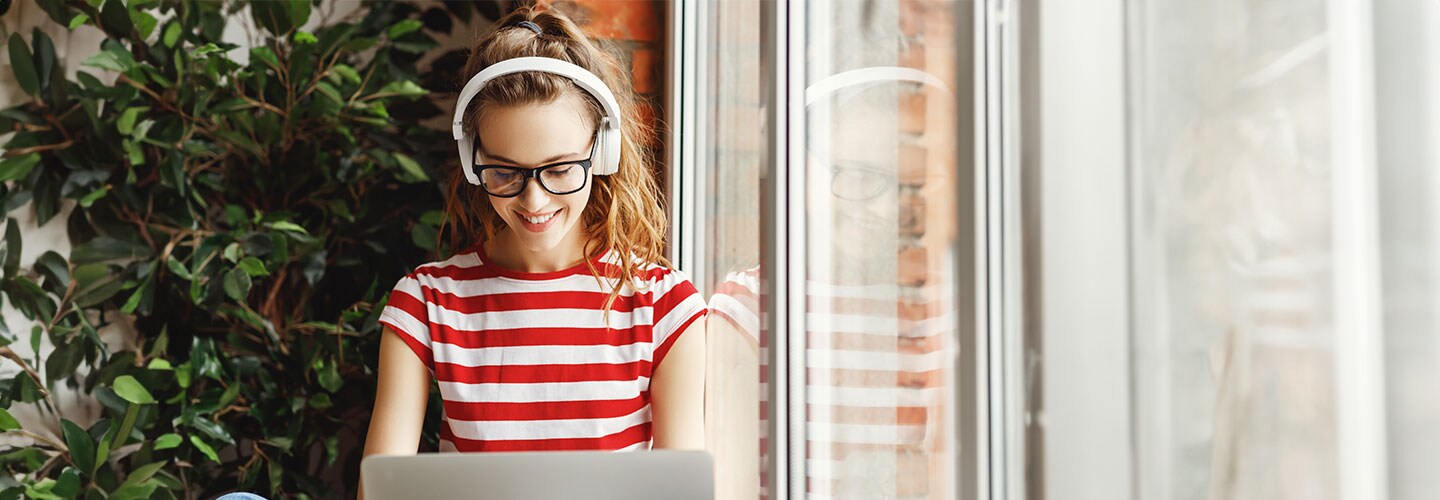 Woman with laptop, smiling