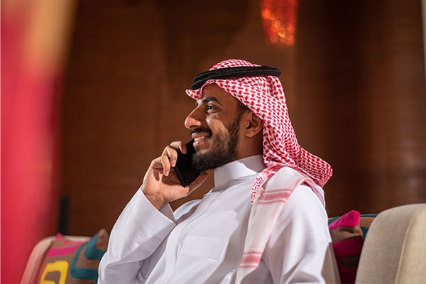 Image of man smiling at mobile phone