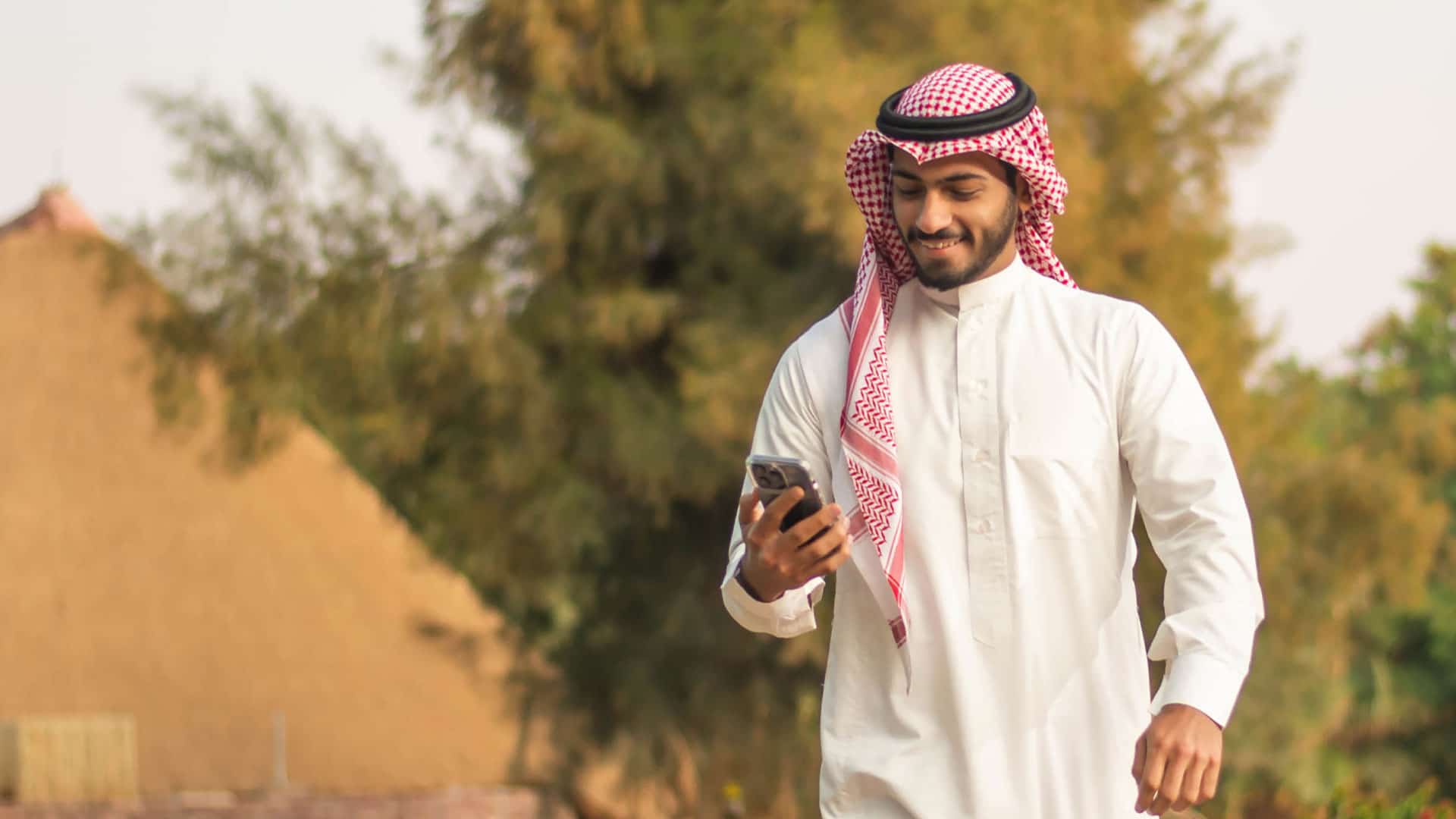 Image of man smiling at mobile phone
