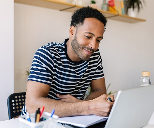 young man concentrates on laptop