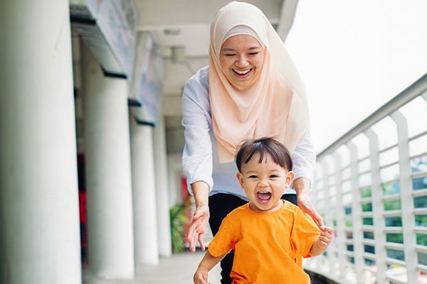 Smiling teacher with primary pupil