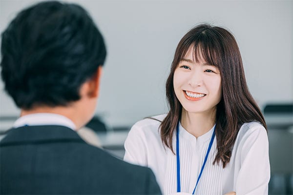 Woman smiling at colleague in a meeting