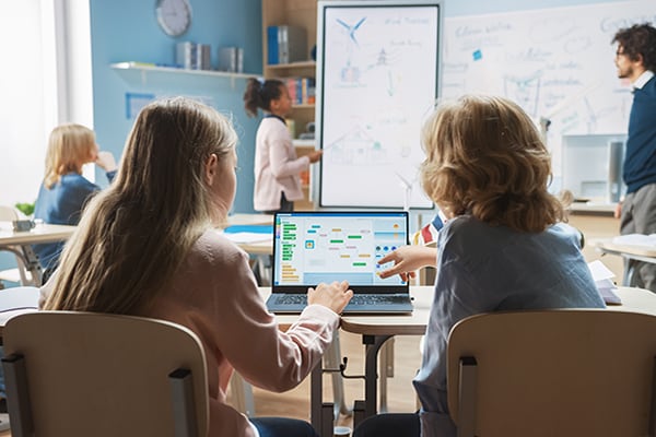 Children in a classroom using a computer