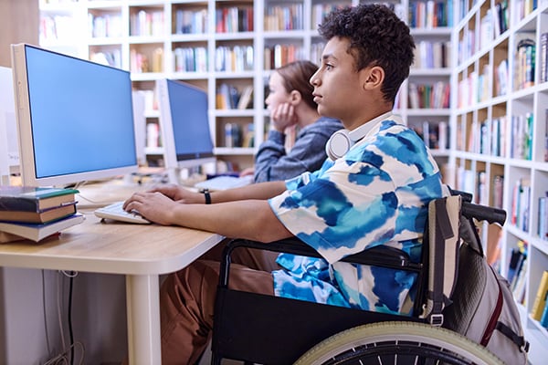 Students in a library taking a test