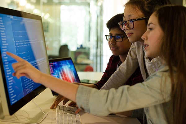 Children using a computer in a classroom