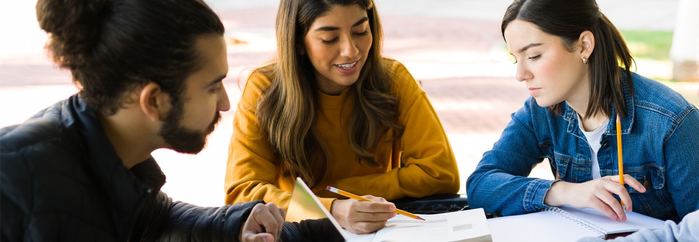 Students studying outside at a table